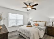 Thumbnail 16 of 33 - a bedroom with a bed and a ceiling fan at The Prairie Villas, Missouri, 63368