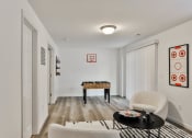 Thumbnail 23 of 33 - a living room with white walls and white furniture and a game table at The Prairie Villas, Dardenne Prairie, MO 63368
