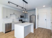 Thumbnail 3 of 32 - a kitchen with white cabinets and stainless steel appliances  at 2200 LaSalle, St Louis