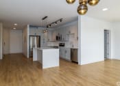 Thumbnail 1 of 32 - a kitchen and dining area with white cabinets and light colored hardwood flooring, at 2200 LaSalle, St Louis, 63104