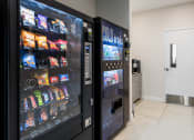 Thumbnail 29 of 32 - a vending machine in the lobby of a building with a door at 2200 LaSalle Apartments, St Louis, MO