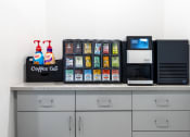 Thumbnail 27 of 32 - a coffee bar with a microwave and other items on a counter at 2200 LaSalle Apartments, St Louis