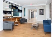 Thumbnail 6 of 32 - clubroom conversational seating area with sofa, two chairs and coffee table at 2200 LaSalle Apartments, St Louis, 63104