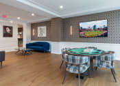Thumbnail 23 of 32 - a dining room with a table and chairs and a tv on the wall at 2200 LaSalle Apartments, St Louis, Missouri