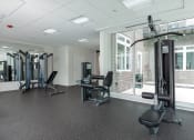 Thumbnail 18 of 32 - a gym with exercise equipment and a large window at 2200 LaSalle Apartments, St Louis, MO, 63104