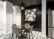 Thumbnail 21 of 32 - a dining room with a table and a painting on the wall at 2200 LaSalle Apartments, Missouri