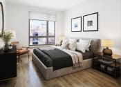 Thumbnail 56 of 58 - a bedroom with a large bed and a large window at Bemiston Place Apartments, Clayton Missouri