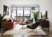 Thumbnail 55 of 58 - a living room with leather furniture and a balcony at Bemiston Place Apartments, Clayton, 63105