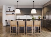 Thumbnail 30 of 58 - a kitchen with a large island and chairs in front of a table at Bemiston Place Apartments, Clayton Missouri