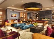 Thumbnail 5 of 58 - a living room filled with furniture and a pool table at Bemiston Place Apartments, Clayton Missouri
