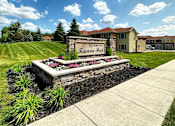 Thumbnail 4 of 45 - A sign that says "The Residences at Fosseana Park" is in front of a building.