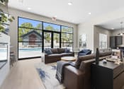 Thumbnail 5 of 28 - a living room with couches and a tv in front of a pool at The Junction at Rogers, Rogers, 72756