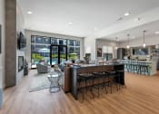 Thumbnail 26 of 33 - modern clubroom with conversational seating, kitchen and coffee bar at The Prairie Villas, Dardenne Prairie Missouri