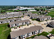 Thumbnail 32 of 32 - A large housing complex with multiple homes and driveways.