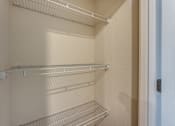Thumbnail 14 of 32 - Empty shelves in a white refrigerator.