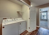 Thumbnail 15 of 32 - A laundry room with a washer and dryer.