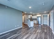 Thumbnail 4 of 32 - A kitchen with a refrigerator, microwave, and oven is visible in the image.