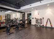 Thumbnail 33 of 46 - A gym with a row of stationary bikes.
