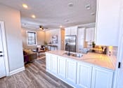 Thumbnail 2 of 18 - A kitchen with a countertop and a refrigerator.