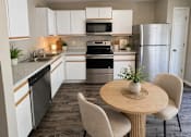 Thumbnail 1 of 19 - A kitchen with a table and chairs.