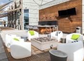 Thumbnail 34 of 42 - a seating area with white chairs and a fire pit at Clayton On The Park, Clayton