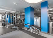 Thumbnail 25 of 42 - a gym with exercise equipment and blue pillars at Clayton On The Park, Missouri