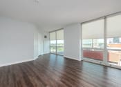 Thumbnail 9 of 42 - an empty living room with wood flooring and large windows at Clayton On The Park, Missouri, 63105