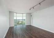 Thumbnail 10 of 42 - an empty living room with wood floors and a window at Clayton On The Park, Clayton, Missouri