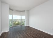 Thumbnail 3 of 42 - an empty living room with wood floors and a window at Clayton On The Park, Missouri, 63105