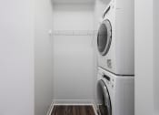 Thumbnail 6 of 42 - a white washer and dryer in a white laundry room at Clayton On The Park, Clayton, 63105