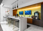 Thumbnail 18 of 42 - a bar with four stools and a coffee machine in a lobby at Clayton On The Park, Missouri, 63105