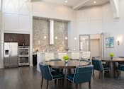 Thumbnail 16 of 23 - a dining room and kitchen with blue chairs and a table