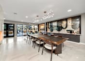 Thumbnail 21 of 36 - A modern dining room with a wooden table and chairs at The Cunningham Apartments, West Des Moines