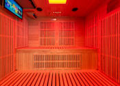 Thumbnail 33 of 46 - A room with wooden benches and a television mounted on the wall.
