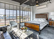 Thumbnail 32 of 39 - Steelcote Crossing bedroom area with concrete flooring and oversized windows at Steelcote Square, St. Louis, Missouri