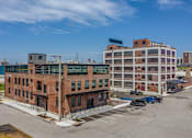 Thumbnail 26 of 39 - Steelcote Crossing exterior historic brick building with Steelcote Lofts in the background  at Steelcote Square, St. Louis, 63103