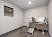 Thumbnail 27 of 36 - A large stainless steel tank in a room with concrete flooring and white walls at The Cunningham Apartments, West Des Moines, 50266