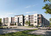 Thumbnail 4 of 6 - A modern apartment complex with a Starbucks in the foreground at Mila Apartments, Ellisville, Missouri