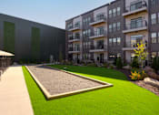 Thumbnail 32 of 36 - A modern apartment complex with a green lawn in front. at The Cunningham Apartments, West Des Moines, 50266