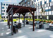 Thumbnail 6 of 39 - Steelcote Flats grilling stations and pergola with seating at Steelcote Square, St. Louis