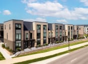 Thumbnail 67 of 71 - a row of townhouses on the side of a street at The Flats & Terraces at Wildhorse Village, Missouri, 63005
