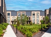 Thumbnail 68 of 71 - a row of apartment buildings with a sidewalk in front of them at The Flats & Terraces at Wildhorse Village, Missouri, 63005