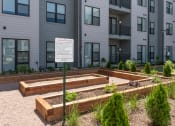 Thumbnail 29 of 71 - a community garden in front of an apartment building at The Flats & Terraces at Wildhorse Village, Chesterfield