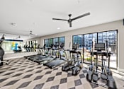Thumbnail 24 of 36 - A gym with treadmills and elliptical machines. at The Cunningham Apartments, Apartments, West Des Moines, IA