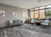 Thumbnail 22 of 28 - a living room with a couch and two chairs and a window at Hibernia Apartments, Missouri, 63139