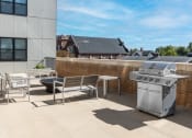 Thumbnail 27 of 28 - Hibernia resident amenity deck with grilling station and fire pit at Hibernia Apartments, St Louis, MO