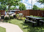Thumbnail 38 of 47 - a picnic area with picnic tables and grills in a park at Grand Flats, St. Louis, 63104
