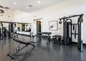 Thumbnail 22 of 28 - A gym with a variety of equipment including a leg press machine at Montage at Hawk Ridge Apartments, Lake St. Louis, 63367, Missouri