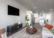 Thumbnail 3 of 28 - A modern living room with a flat screen TV mounted on the wall at Montage at Hawk Ridge Apartments, Lake St. Louis, 63367, Missouri