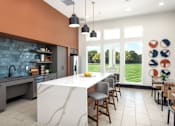 Thumbnail 16 of 28 - A kitchen with a marble island and a view of the backyard at Montage at Hawk Ridge Apartments, Lake St. Louis, 63367, MO
